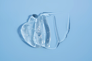 The texture of a cosmetic gel on a blue background.