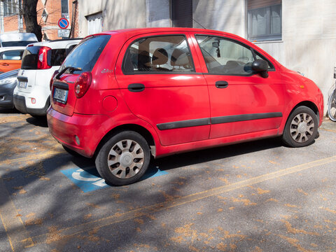Cremona, Italy March 15th 2025 Red Chevrolet Matiz parked in a disabled parking space