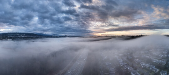 Aerial View of Foggy Urban Landscape with Sunrise Over BC, Canada