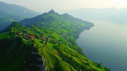 Fototapeta premium Scenic alpine valley, village nestled on mountainside overlooking lake