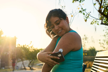Diabetic patient woman doing exercises. Continuous Glucose Monitor and active sugar diabetes...