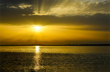 Sunset over the sea. Cloudy sunset over sea horizon
