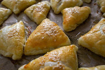 Freshly baked golden samosa with sesame seeds