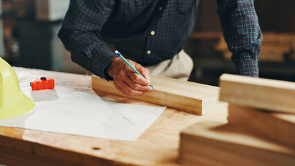 Pencil, carpenter hands and mark wood to measure for construction, furniture or project. Woodworker, person and plank with tools in creative carpentry workshop for manufacturing, art and craft