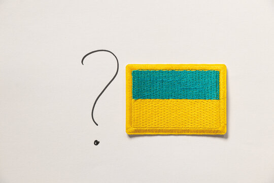 Drawn question mark and flag of Ukraine on white background
