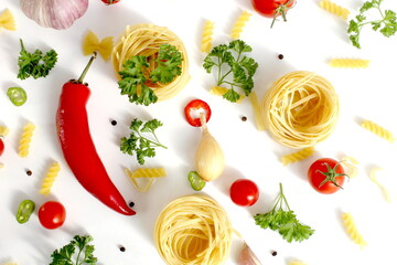 On a white background lies macaroni nests and vegetables.Texture.