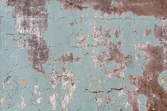 Texture of cracked painted plaster on a wall.