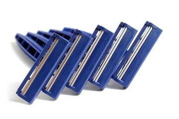 Several men's razors lie on a white background.