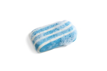On a white background lies a striped blue soap with foam.