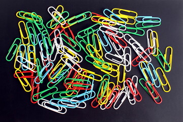 Texture of multi-colored bright iron office paper clips.