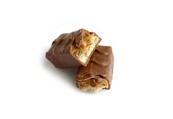 Two broken pieces of chocolate bar lie on a white background.