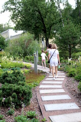 Fototapeta premium People are walking along a beautiful path in the park.