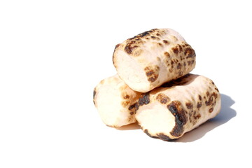 On a white background lies a marshmallow baked on a fire.	