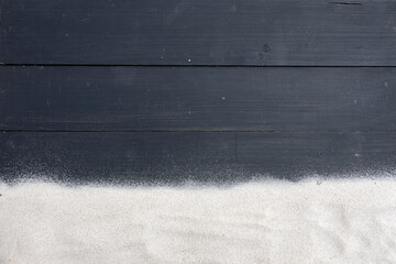 Minimalist Contrast of White Sand and Black Wooden Planks
