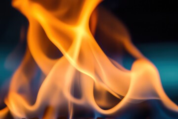 Vibrant orange flames dancing against a dark blue background