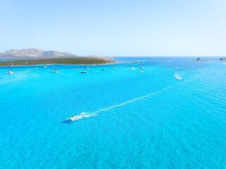 Vacation and leisure. Aerial view on fast boat on blue Mediterranean sea at sunny day. Seascape with motorboat. Azure sea water and waves. Background, postcards, wallpapers.