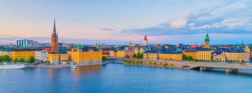 Fototapeta Stockholm, Sweden. Panoramic view of the Gamla Stan. The capital of Sweden. Cityscape during sunset. View of the old town in Stockholm. Photo for background, wallpaper, postcards.