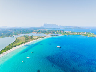 Drone view of the sea coast. Shore and sea water. Vacation and travel. Summer seascape. Transparent sea water and waves. Photography for background, postcards, wallpapers.