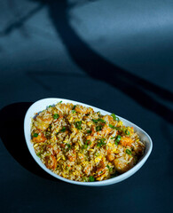 Prepared fried rice in a bowl, fried rice served in a white bowl, typical Asian fried rice dish, healthy homemade fried rice