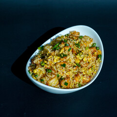 Prepared fried rice in a bowl, fried rice served in a white bowl, typical Asian fried rice dish, healthy homemade fried rice
