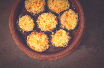 Portabello mushrooms stuffed with suluguni cheese in a clay pan, ketsi, Georgian cuisine, hot appetizer,