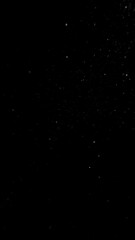 Freeze motion of dust particles flying , isolated on black background