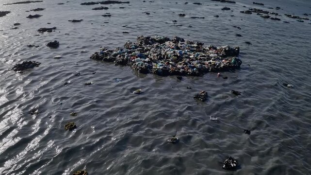 Aerial View of Multiple Plastic Waste Islands Floating on Silver Ocean