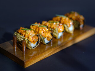 Sushi, japanese food, sushi taco, served on a wooden slate, sushi roll taco with salmon, cheese, caviar, shrimps, avocado