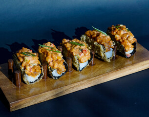 Sushi, japanese food, sushi taco, served on a wooden slate, sushi roll taco with salmon, cheese, caviar, shrimps, avocado