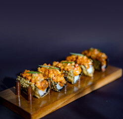 Sushi, japanese food, sushi taco, served on a wooden slate, sushi roll taco with salmon, cheese, caviar, shrimps, avocado