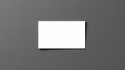 Blank Business Card on Gray: A clean, minimalist image of a blank business card resting on a dark gray surface, perfect for mockups, presentations, and showcasing design