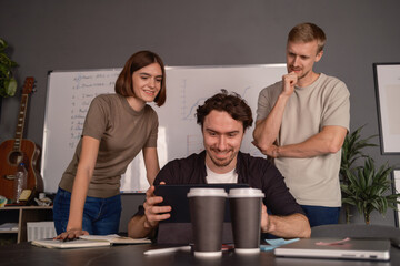 Coworkers discussing ideas while working together in a modern conference room setting