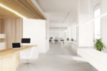 Blurred open office with minimalist decor and natural wood accents