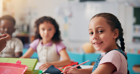 Portrait, education and writing with girl in classroom for child development, future and learning. Academy, growth and scholarship with kid and students in school for knowledge, lesson and study