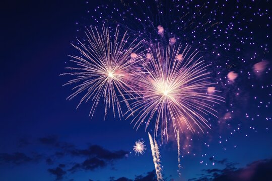 Vibrant fireworks explode in a twilight sky