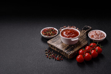 Red sauce or ketchup with salt and spices in ceramic sauce boat