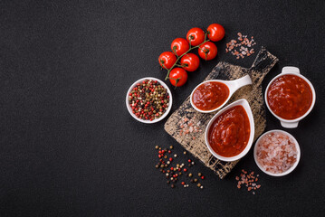 Red sauce or ketchup with salt and spices in ceramic sauce boat