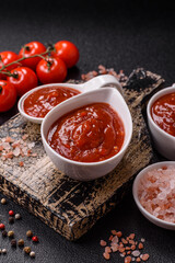 Red sauce or ketchup with salt and spices in ceramic sauce boat