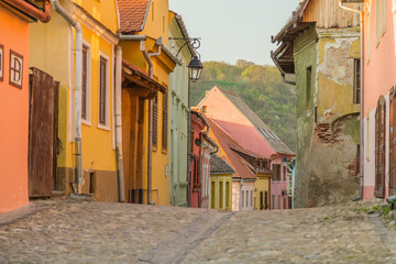 Colourful street in Sighisoara, Romania. Colorful street climbing the fortress hill in the medieval transylvanian town Sighisoara, Romania
