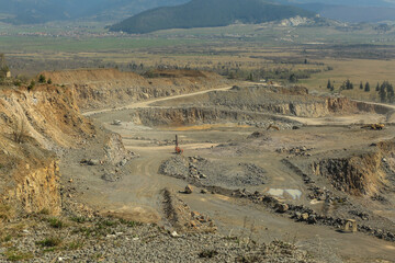 A large limestone quarry with exposed rocky walls, creating an impressive natural landscape
