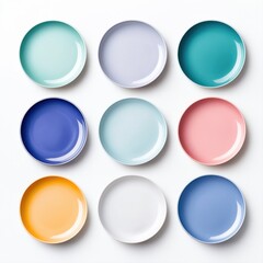 Vibrant Collection of Round Empty Plates in Various Colors Arranged in a Grid Pattern on White Background