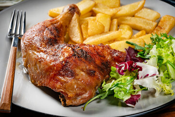 Appetizing baked chicken leg quarter.