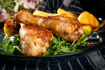 Baked chicken drumsticks with potatoes.