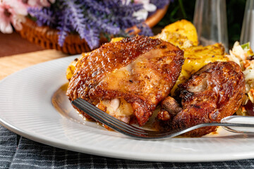 Appetizing baked chicken leg quarter.