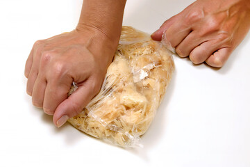 plastic packaging with cod chips being prepared by female hands