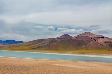 Lagunas altiplanicas Miniques and Miscanti in Chile Atacama desert near San Pedro de Atacama village. Tourist attractions natural sights of Chilean Atacama desert. Dry soil and volcano mountain Andes