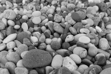 Natural background made of round grey and black stones as pattern.Copy space,layout