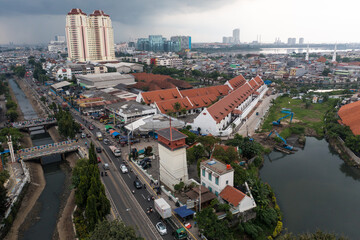 Jakarta, Indonesia - July 15, 2022: Aerial view of Pelindo Building (Maritime Tower) a unique building located in North Jakarta with the sunset in the background.