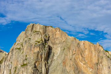 Fototapeta premium Brevent mountain summit in Chamonix valley. Rocky mountain top with cable car famous for climbing, hiking and paragliding from its slopes. Brevent summit in the Alps on a sunny day