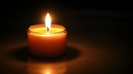 Single candle lighting up a dark room symbolizing hope in adversity